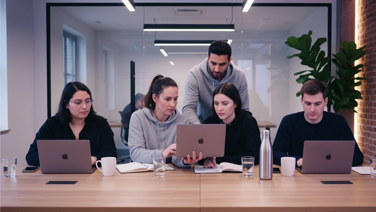 A diverse engineering team achieving hiring alignment and confidence using Maslow in a busy, scaling startup office.